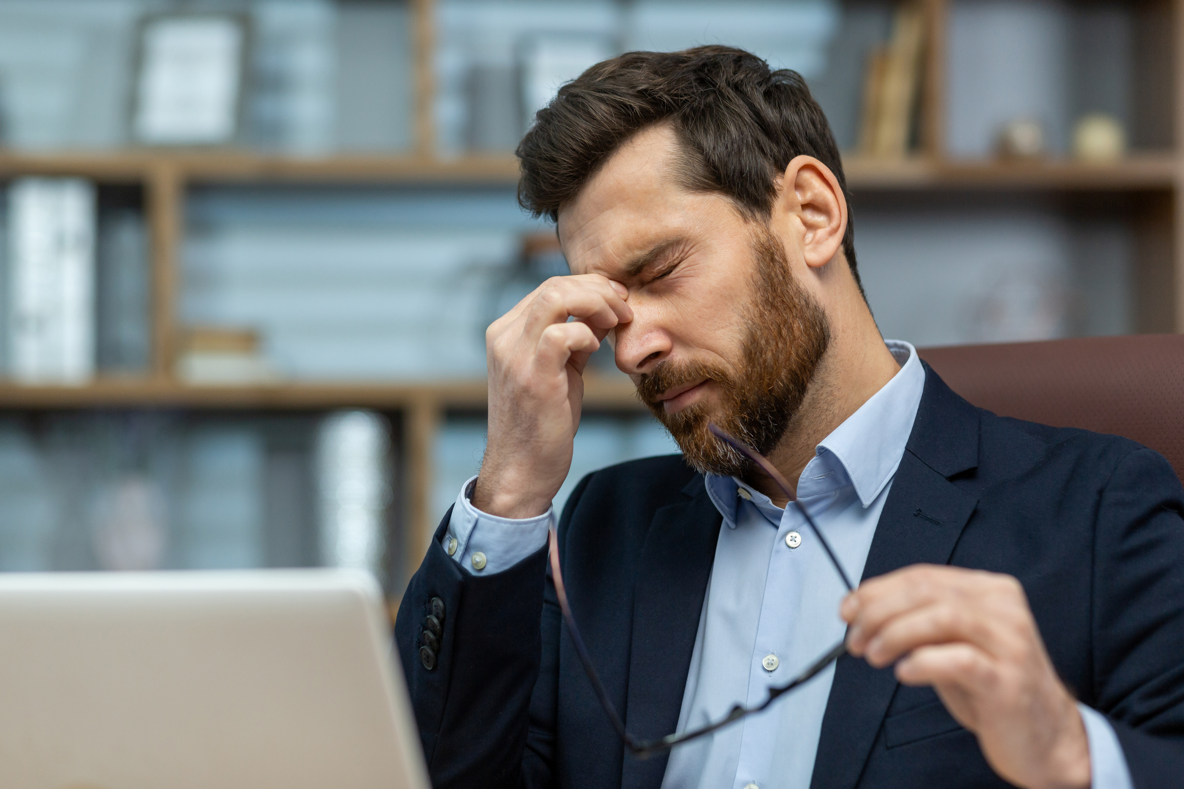 A construction industry leader experiencing stress during change management, reflecting the pressure leaders face when change efforts fail in AEC.