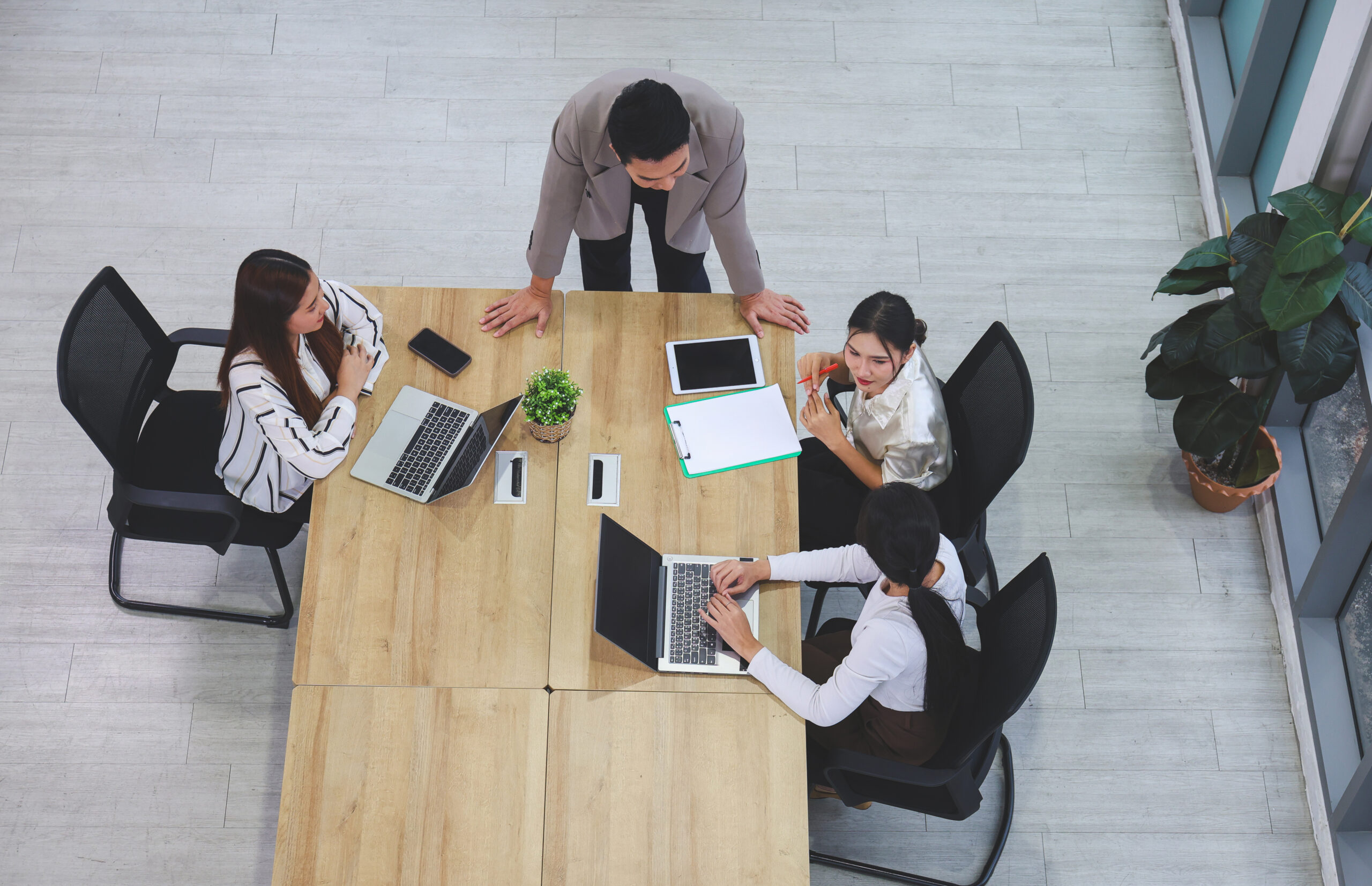 AEC leadership team discussing project decisions together during organizational change in the Architectural, Engineering, and Construction industry.
