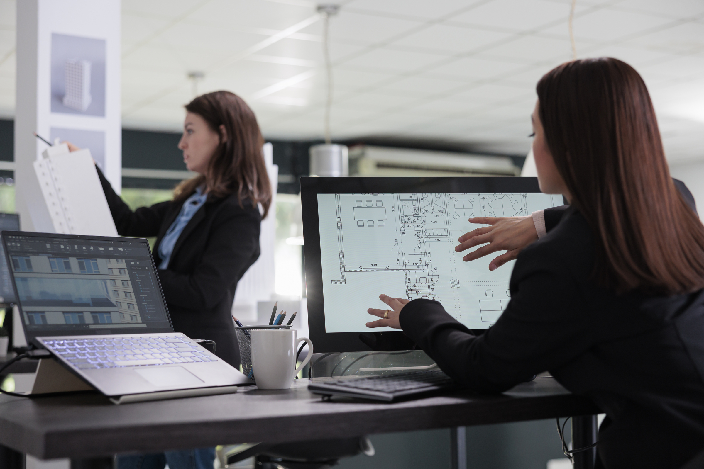 AEC professionals collaborating on digital workflows and technology adoption during organizational transformation