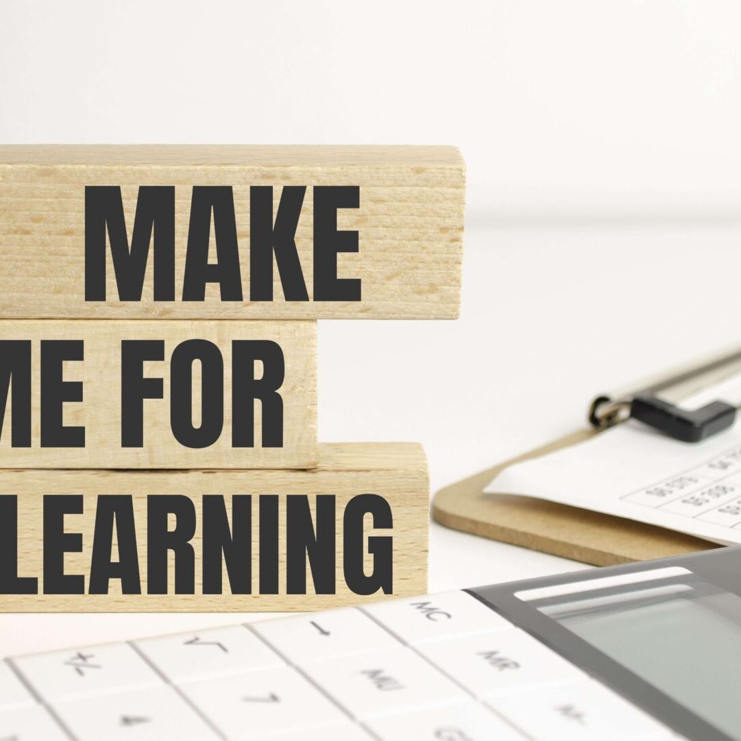 A wooden block that says make time for e-learning